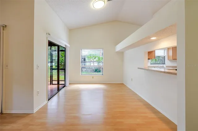 an empty room with windows and entrance