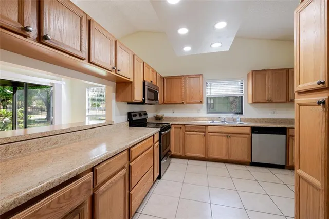 a kitchen with stainless steel appliances granite countertop a sink and cabinets