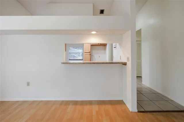 a view of a room with wooden floor and cabinet