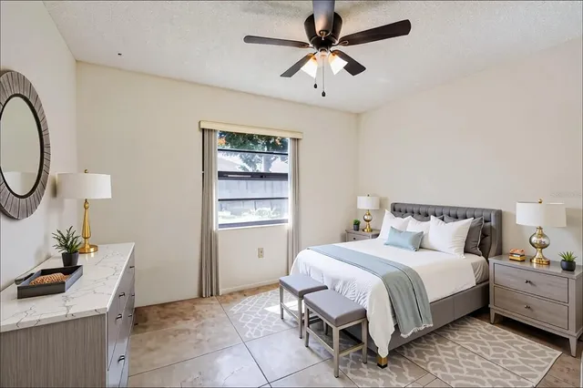 a bedroom with a bed a desk and chair