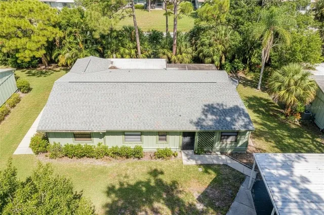 a view of a house with yard and sitting area
