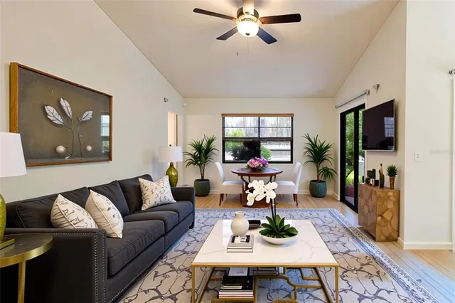 a living room with furniture a rug and a flat screen tv