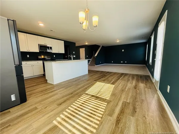 a view of kitchen with microwave and cabinets