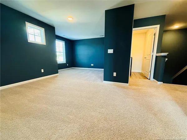 a bedroom with a bed and a lamp