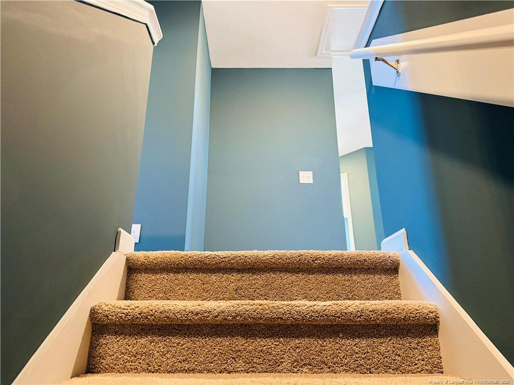 4029 Racking Horse Road Hope Mills, NC 28306 - Photo 14 of 30 a bedroom with a bed and wooden floor