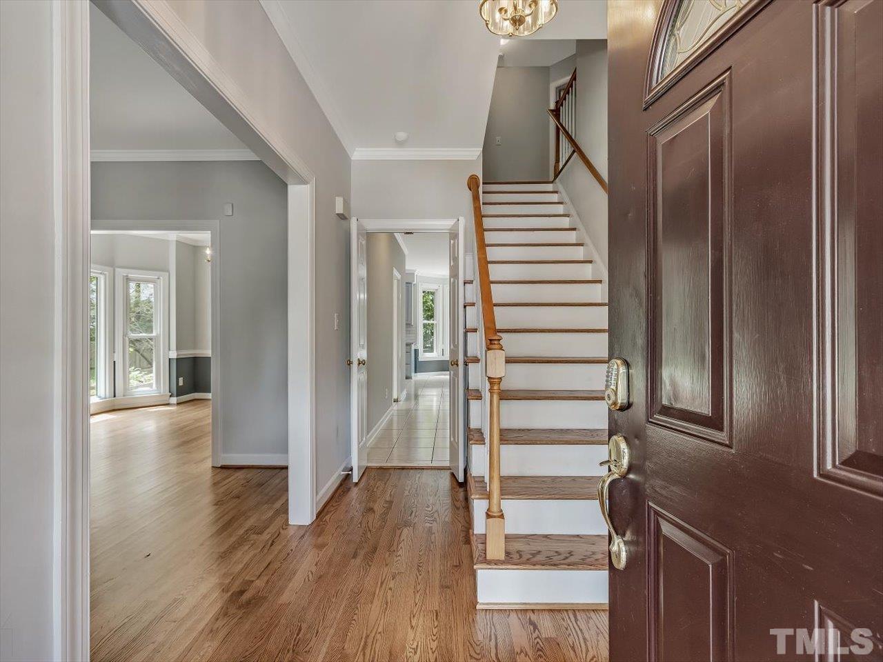 4 Caspian Court Durham, NC 27713 - Photo 11 of 84 a view of a hallway with wooden floor and windows