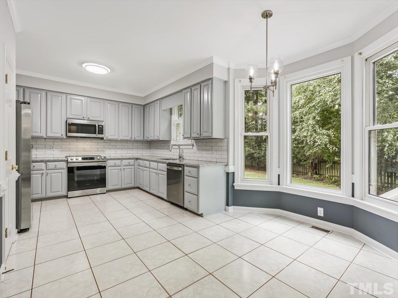 4 Caspian Court Durham, NC 27713 - Photo 16 of 84 a kitchen with stainless steel appliances a sink window and cabinets
