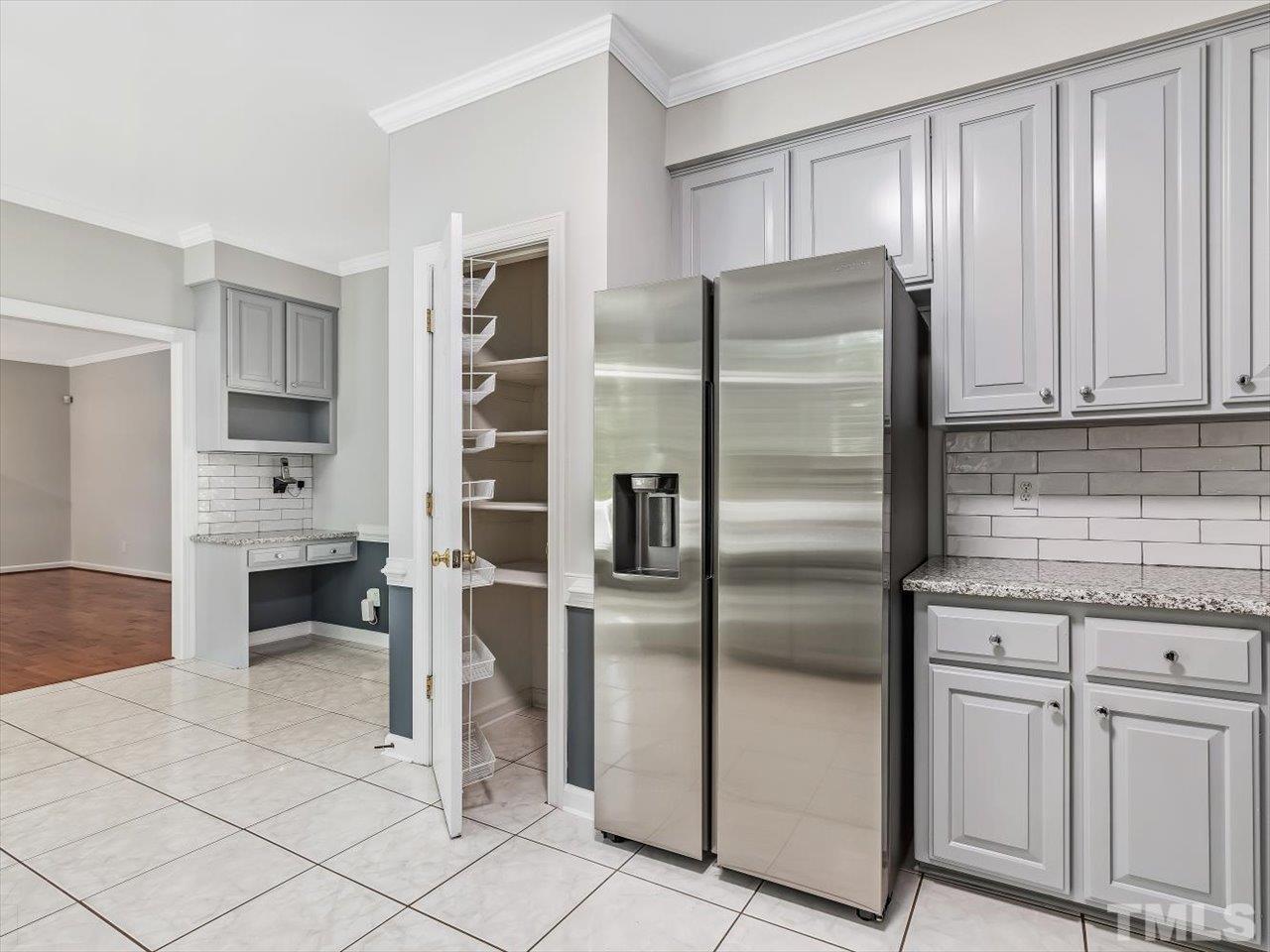 4 Caspian Court Durham, NC 27713 - Photo 19 of 84 a kitchen with stainless steel appliances kitchen island granite countertop a refrigerator and cabinets