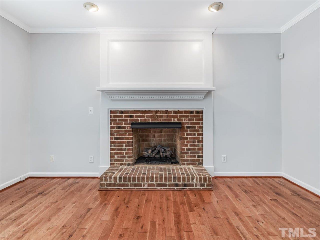 4 Caspian Court Durham, NC 27713 - Photo 21 of 84 a view of an empty room with wooden floor fireplace and a window