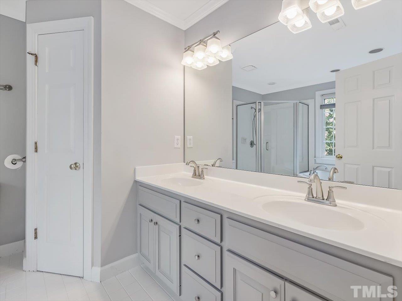 4 Caspian Court Durham, NC 27713 - Photo 33 of 84 a bathroom with a sink double vanity and a mirror