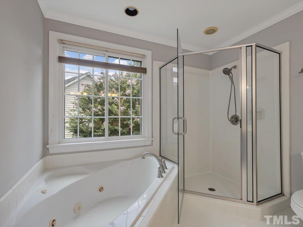 4 Caspian Court Durham, NC 27713 - Photo 34 of 84 a bathroom with a bathtub and a shower