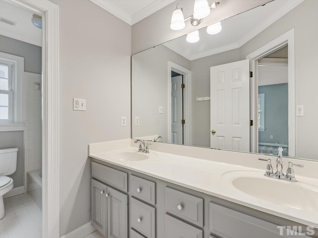 4 Caspian Court Durham, NC 27713 - Photo 40 of 84 a bathroom with a sink vanity and a mirror