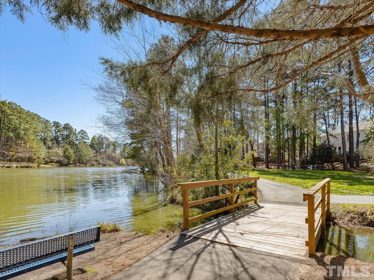 4 Caspian Court Durham, NC 27713 - Photo 81 of 84 a view of a lake with a yard and a wooden deck