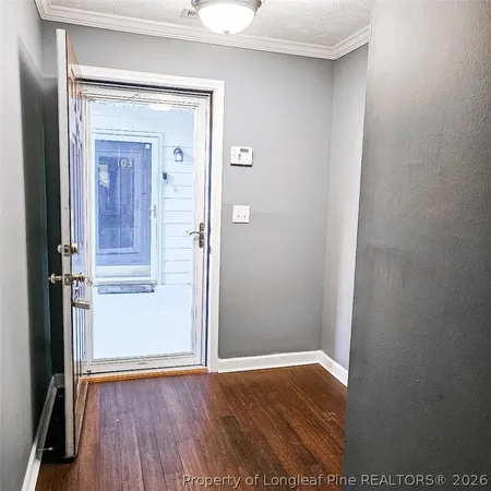 a view of a hallway with wooden floor