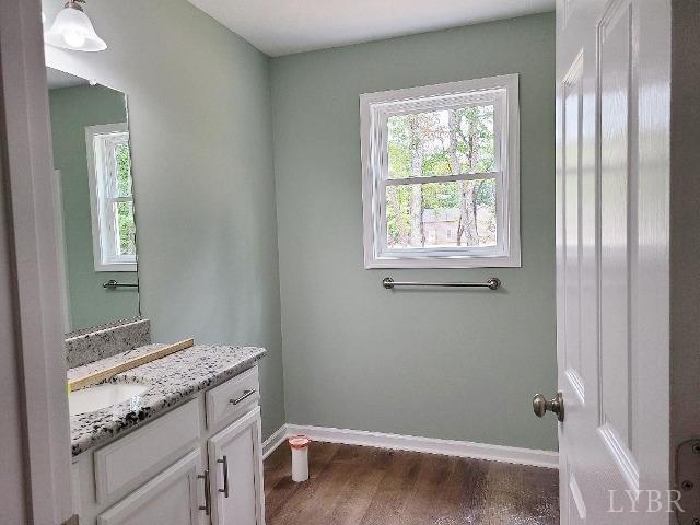2711 Stonewall Road Concord, VA 24538 - Photo 11 of 14 a bathroom with a granite countertop sink and a window