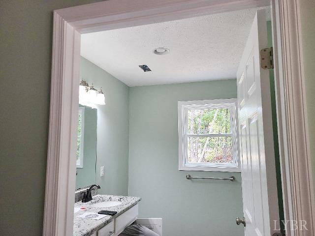 2711 Stonewall Road Concord, VA 24538 - Photo 14 of 14 a bathroom with a window sink and a mirror