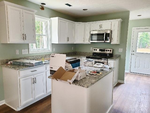 2711 Stonewall Road Concord, VA 24538 - Photo 5 of 14 a kitchen with stainless steel appliances granite countertop a stove a sink and a microwave