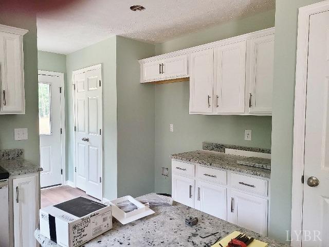 2711 Stonewall Road Concord, VA 24538 - Photo 7 of 14 a kitchen with stainless steel appliances white cabinets and a sink