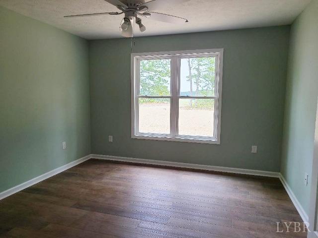 2711 Stonewall Road Concord, VA 24538 - Photo 8 of 14 an empty room with a window and a fan