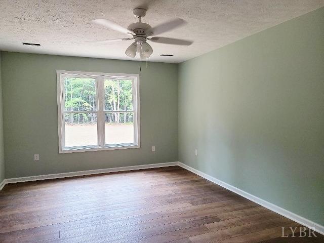 2711 Stonewall Road Concord, VA 24538 - Photo 9 of 14 an empty room with wooden floor and windows