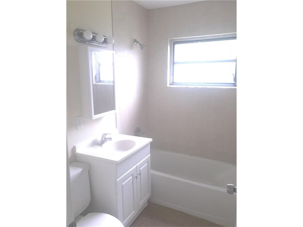 330 6th Road Southwest Vero Beach, FL 32962 - Photo 4 of 7 a bathroom with a sink a toilet and shower