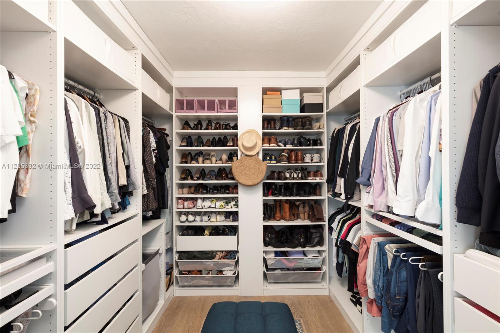9 Pinta Road Miami, FL 33133 - Photo 15 of 25 a view of walk in closet with clothes and shoes