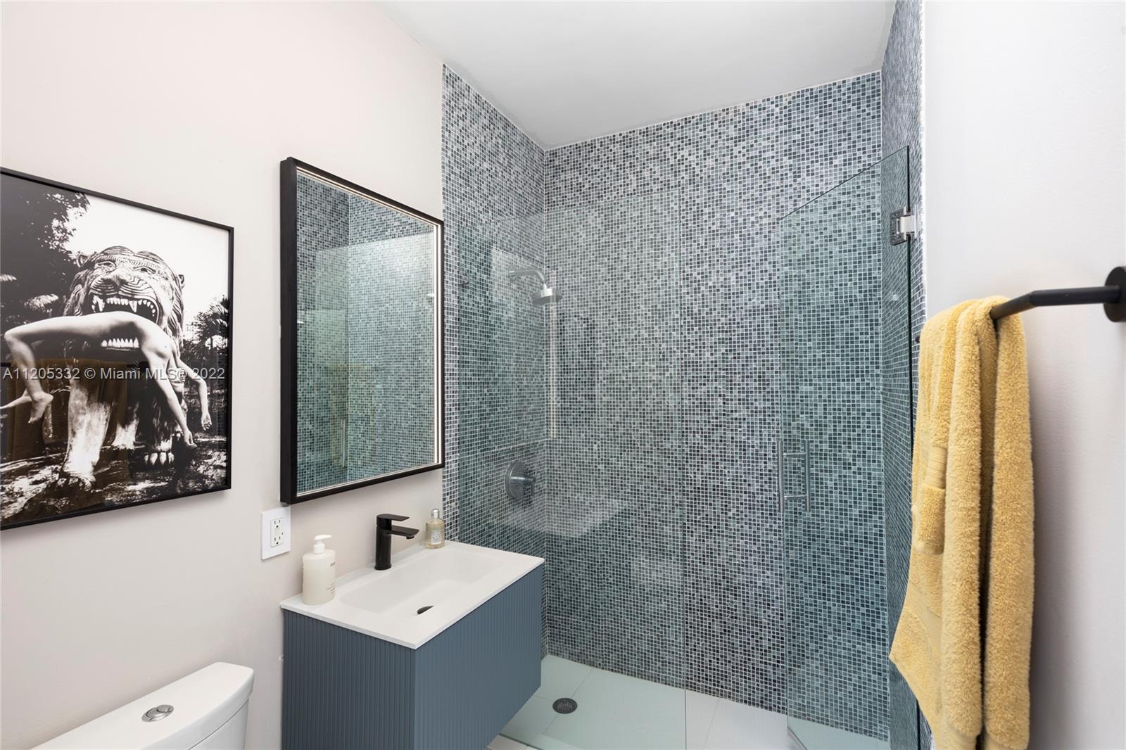 9 Pinta Road Miami, FL 33133 - Photo 17 of 25 a bathroom with a sink and a mirror