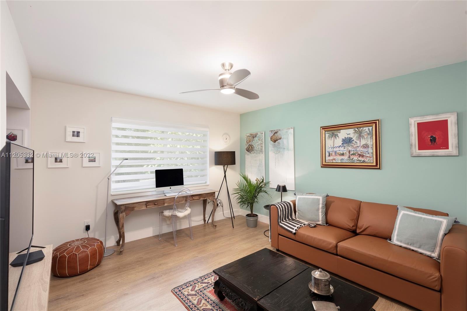 9 Pinta Road Miami, FL 33133 - Photo 18 of 25 a living room with furniture and a flat screen tv