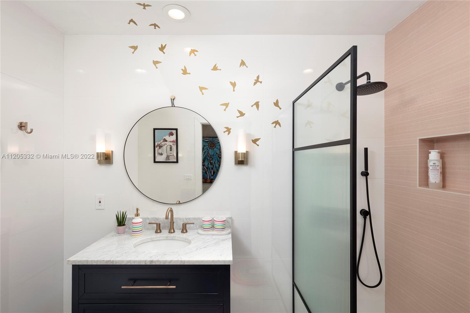 9 Pinta Road Miami, FL 33133 - Photo 19 of 25 a bathroom with a sink mirror and a mirror