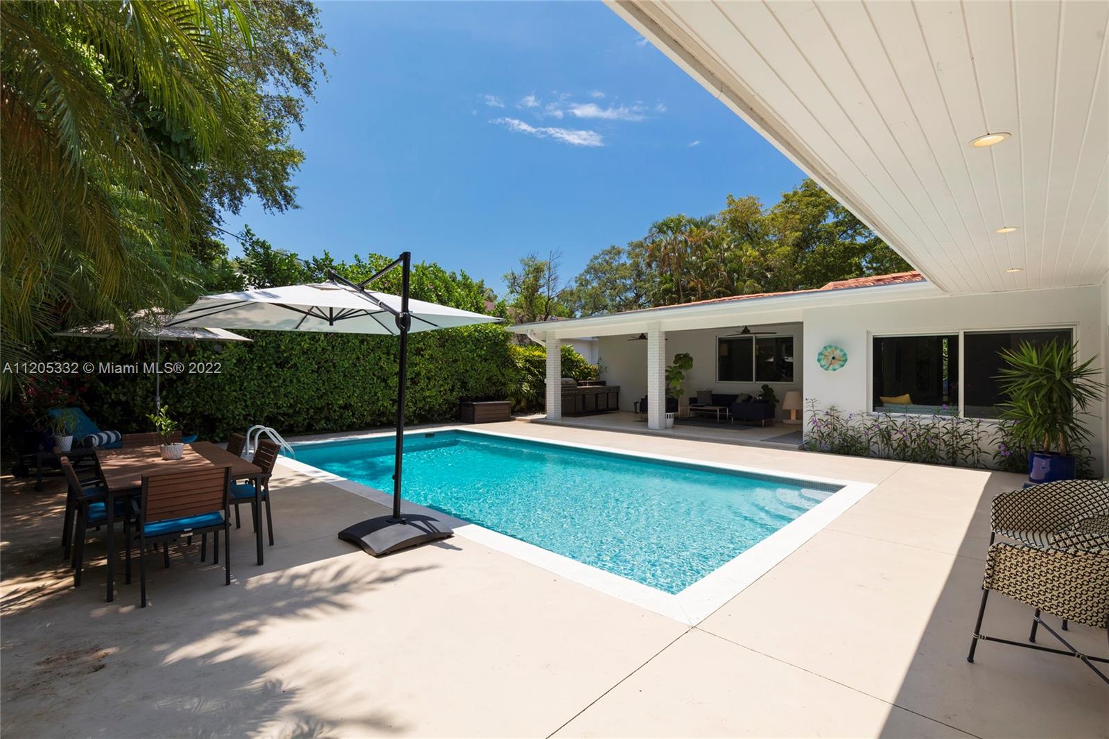 9 Pinta Road Miami, FL 33133 - Photo 21 of 25 a view of a house with backyard sitting area and garden