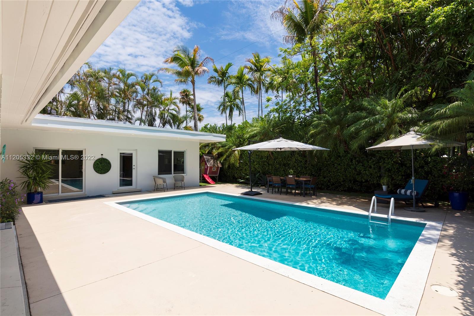 9 Pinta Road Miami, FL 33133 - Photo 22 of 25 a view of a house with backyard and sitting area