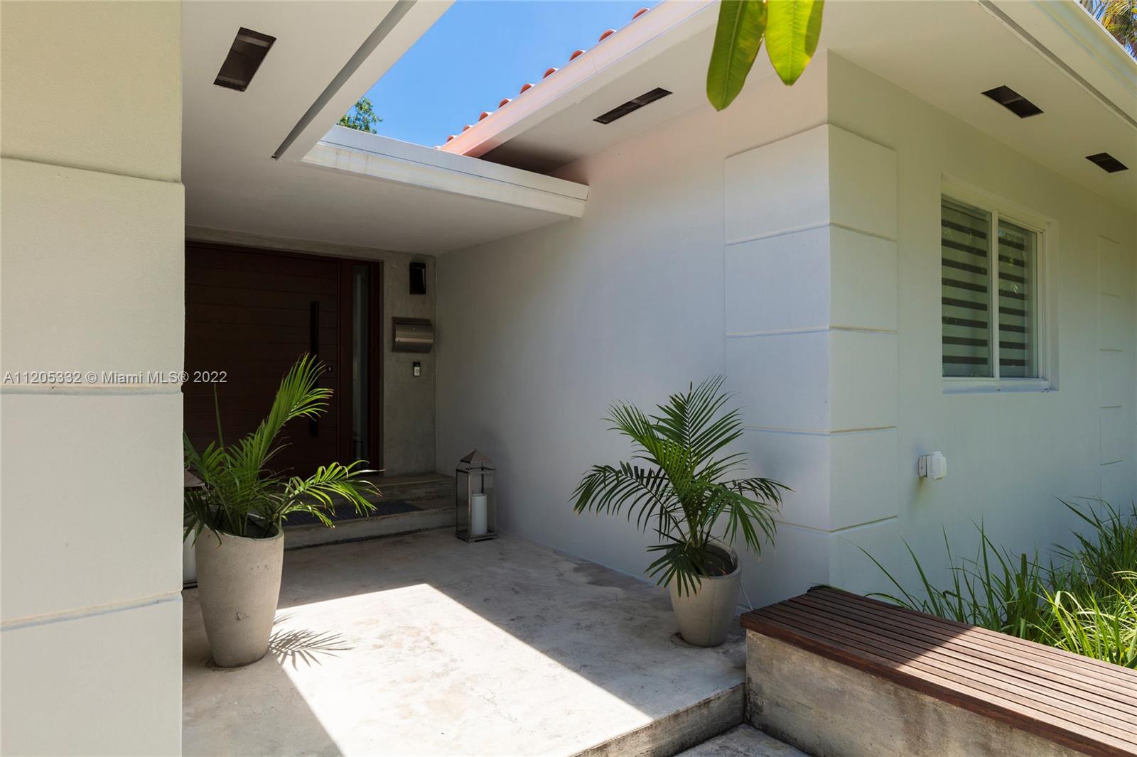 9 Pinta Road Miami, FL 33133 - Photo 3 of 25 a potted plant sitting in front of a house