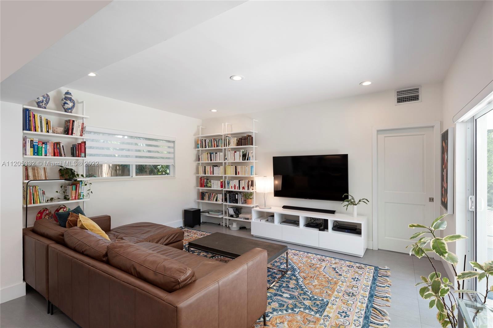 9 Pinta Road Miami, FL 33133 - Photo 7 of 25 a living room with furniture and a flat screen tv