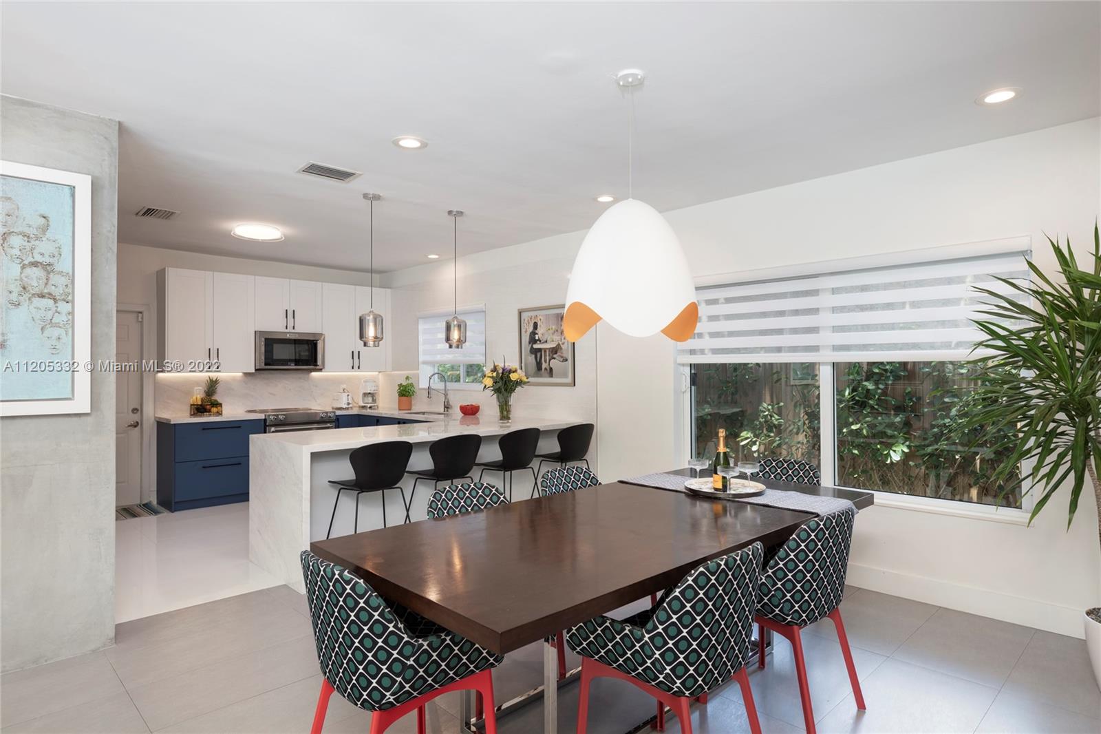 9 Pinta Road Miami, FL 33133 - Photo 9 of 25 a dining hall with stainless steel appliances kitchen island a table and chairs