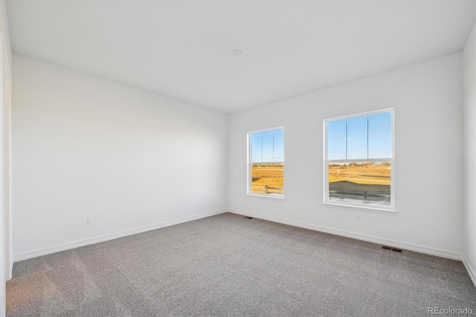 1162 Weller Street Timnath, CO 80547 - Photo 11 of 29 an empty room with windows