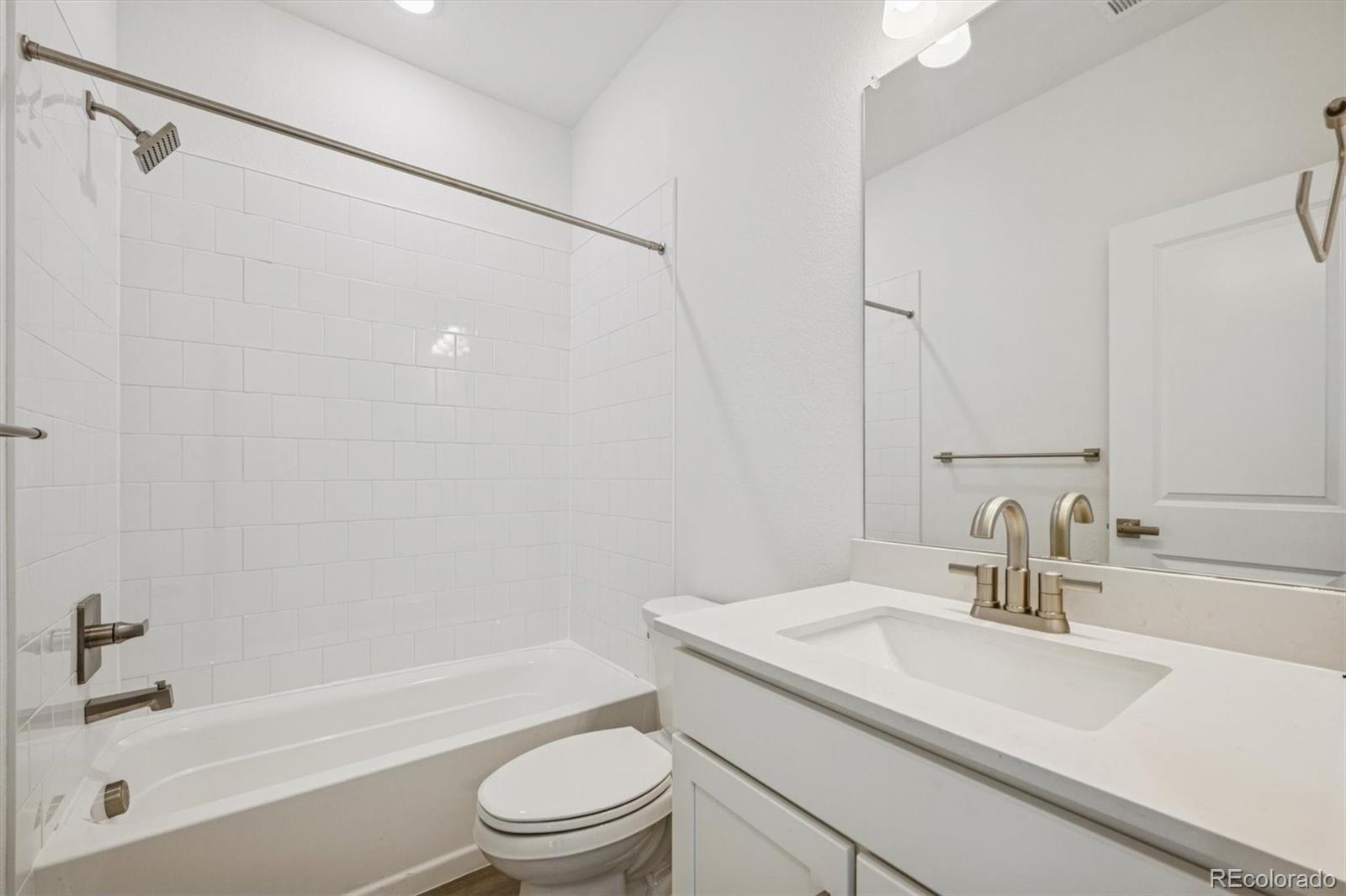 1162 Weller Street Timnath, CO 80547 - Photo 23 of 29 a bathroom with a granite countertop sink toilet and shower