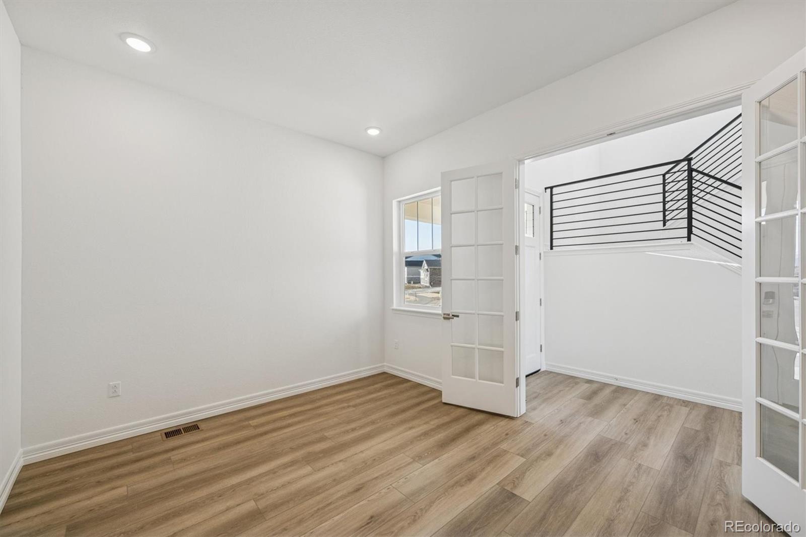 1162 Weller Street Timnath, CO 80547 - Photo 3 of 29 a view of empty room with wooden floor