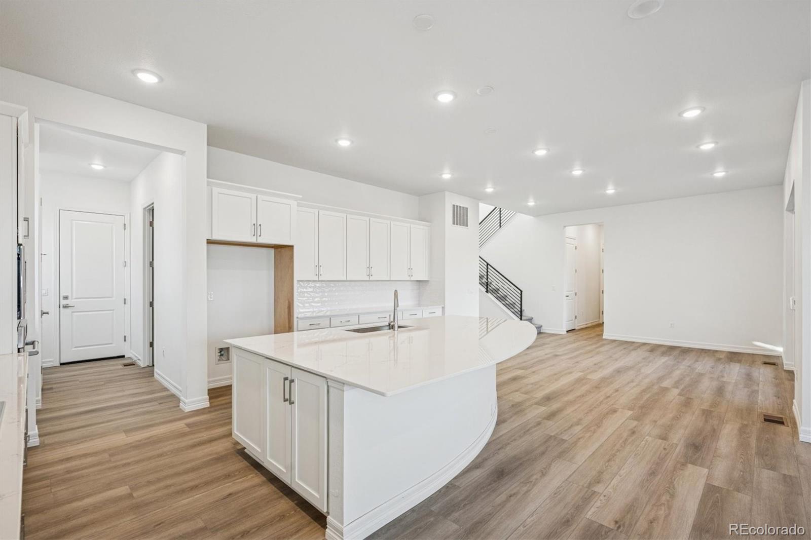 1162 Weller Street Timnath, CO 80547 - Photo 6 of 29 an open kitchen with a sink and refrigerator
