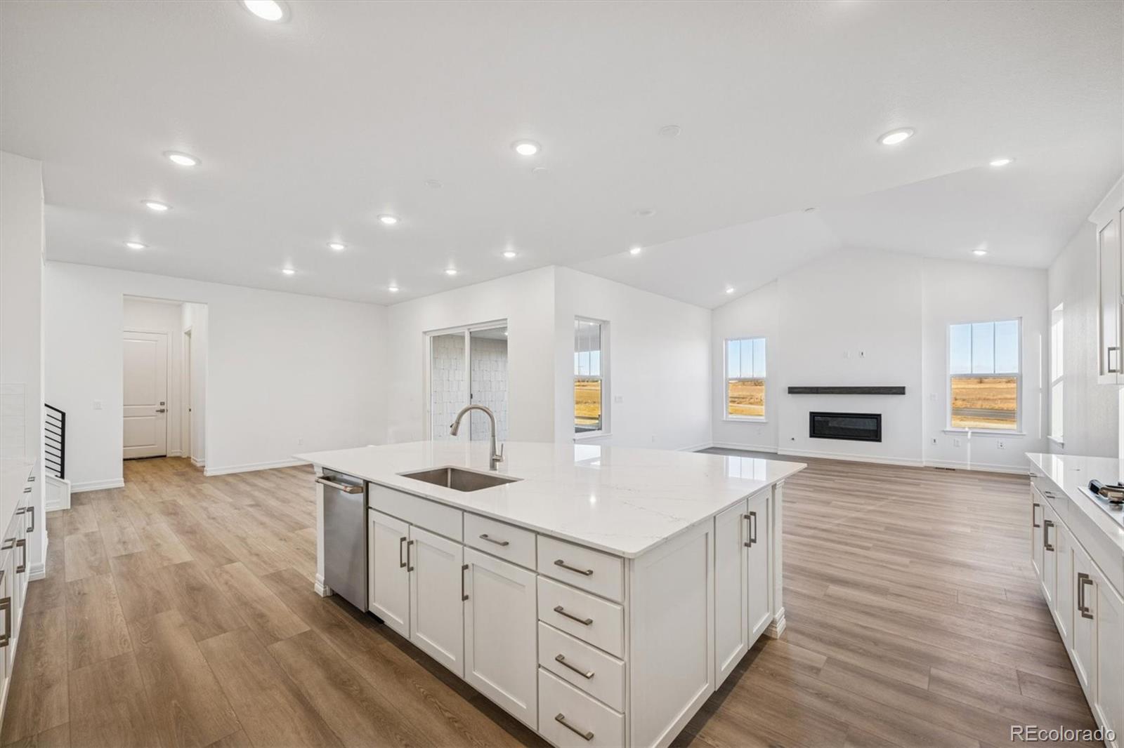 1162 Weller Street Timnath, CO 80547 - Photo 8 of 29 a kitchen with a sink wooden floor and a kitchen view