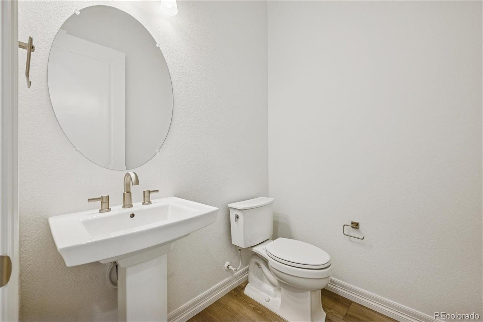 1162 Weller Street Timnath, CO 80547 - Photo 10 of 29 a bathroom with a toilet a sink and mirror