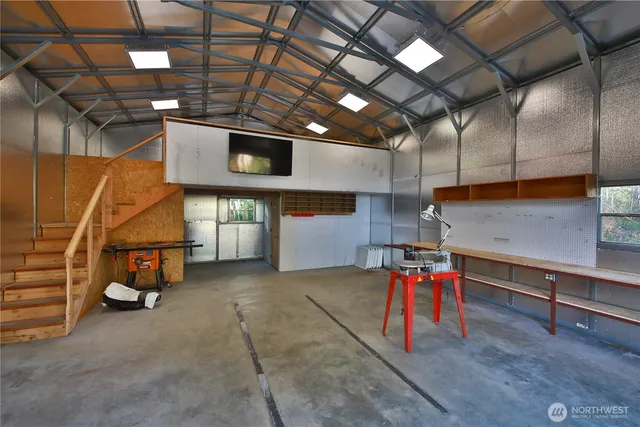a view of a lobby with a chair and potted plant