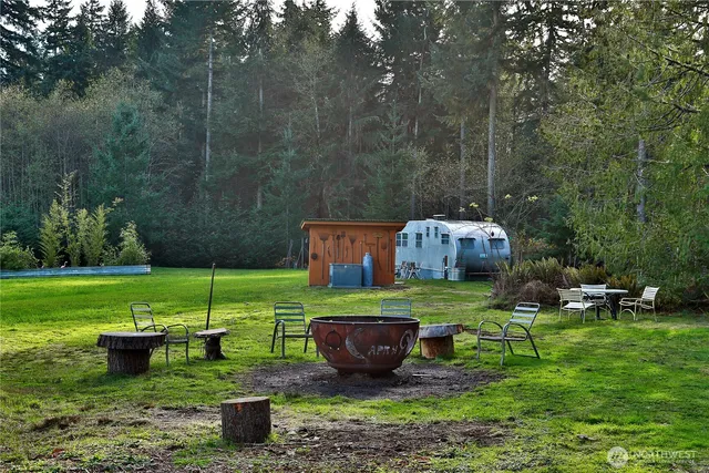 a view of a backyard with swimming pool