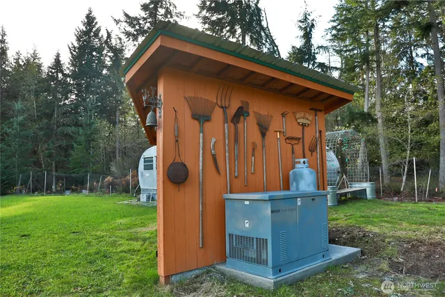 a view of a swimming pool and lounge chairs in back yard of the house