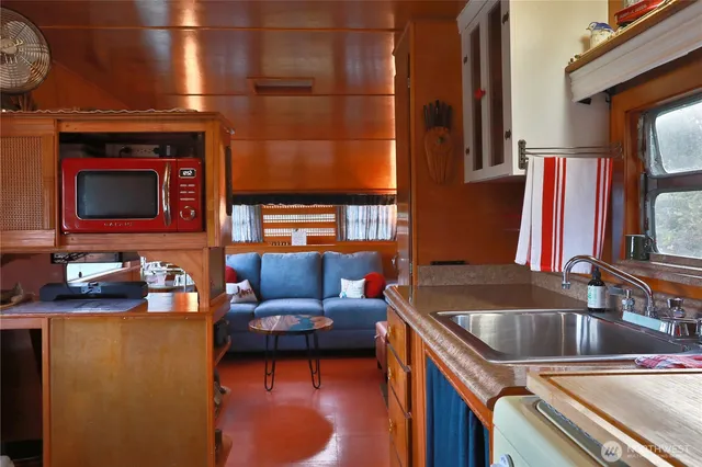 a bedroom with a bed and a lamp with the stairs