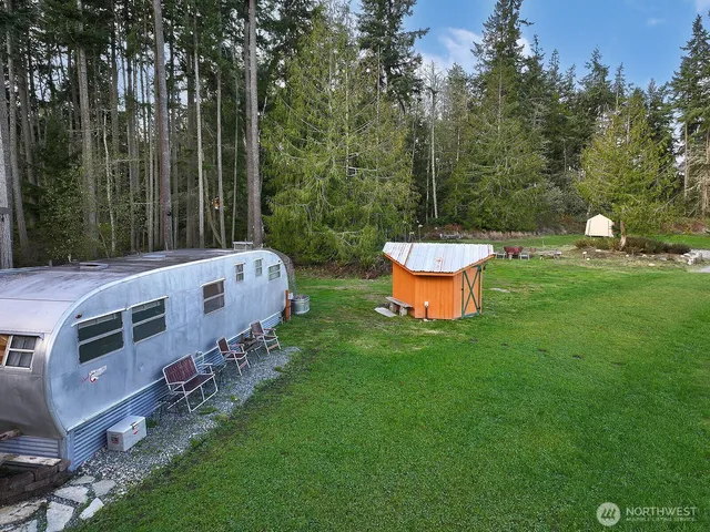 a backyard of a house with table and chairs