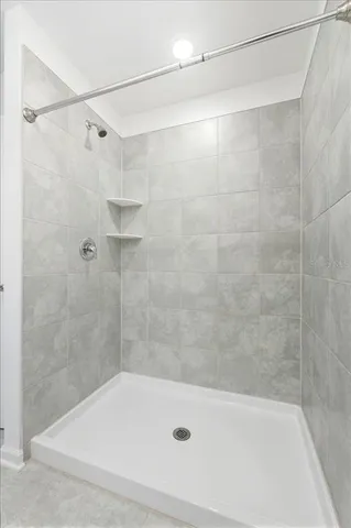a bathroom with a shower and a bath tub