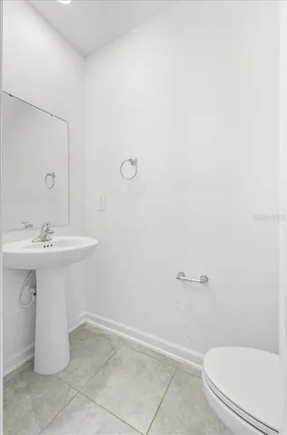 a bathroom with a sink a toilet and mirror