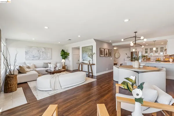 a living room with furniture kitchen view and a table