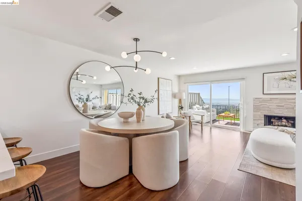 a room with furniture a clock and white walls