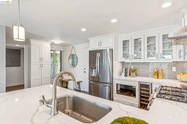 a kitchen with stainless steel appliances granite countertop a refrigerator sink and cabinets